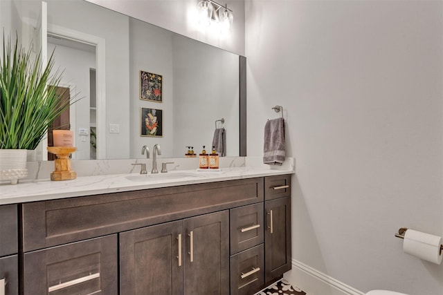 bathroom with vanity and baseboards