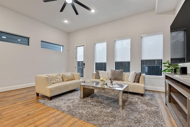 living room featuring a ceiling fan, recessed lighting, baseboards, and wood finished floors