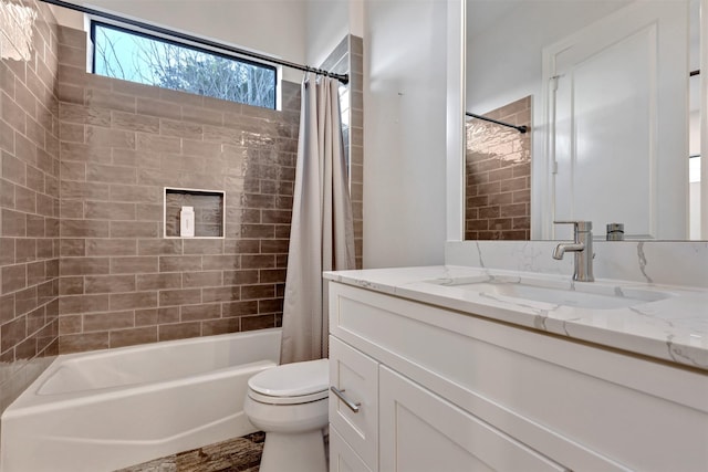 bathroom featuring toilet, shower / bath combo, and vanity