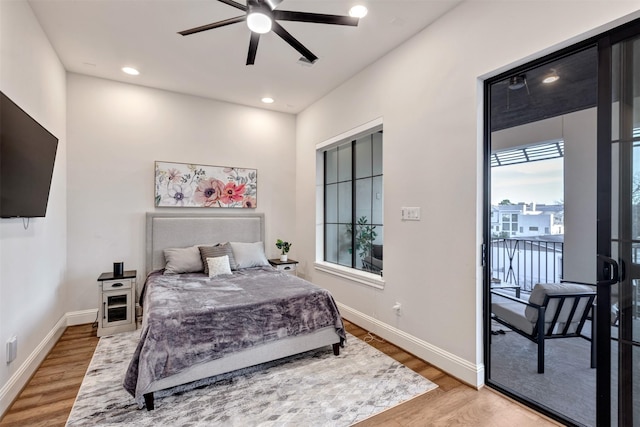 bedroom with access to exterior, baseboards, and light wood finished floors