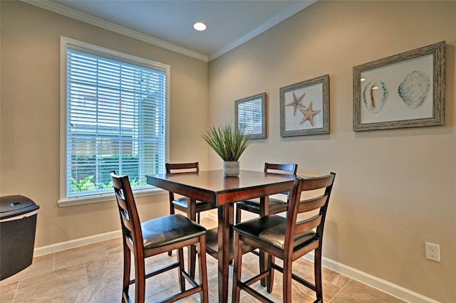 dining room featuring baseboards, recessed lighting, and crown molding