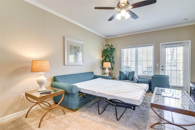 living area with light tile patterned floors, a ceiling fan, baseboards, and crown molding