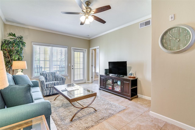 living room featuring ornamental molding, visible vents, baseboards, and a ceiling fan