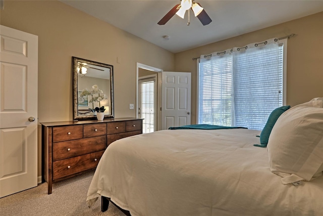 bedroom featuring light colored carpet and ceiling fan