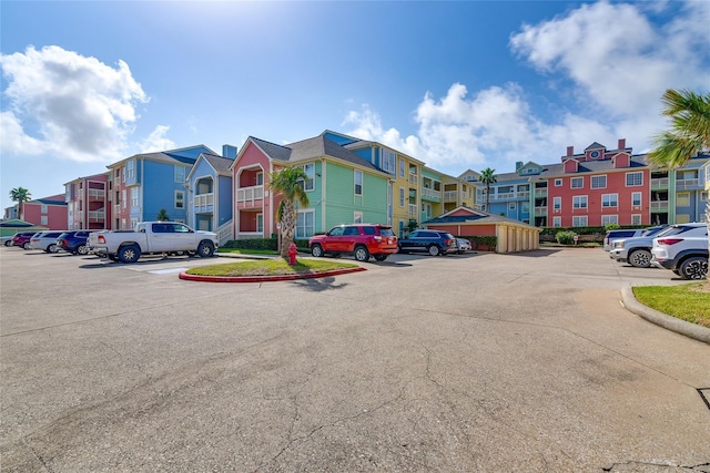 uncovered parking lot featuring a residential view