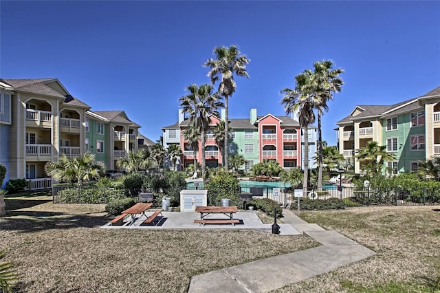 view of community with a residential view and fence