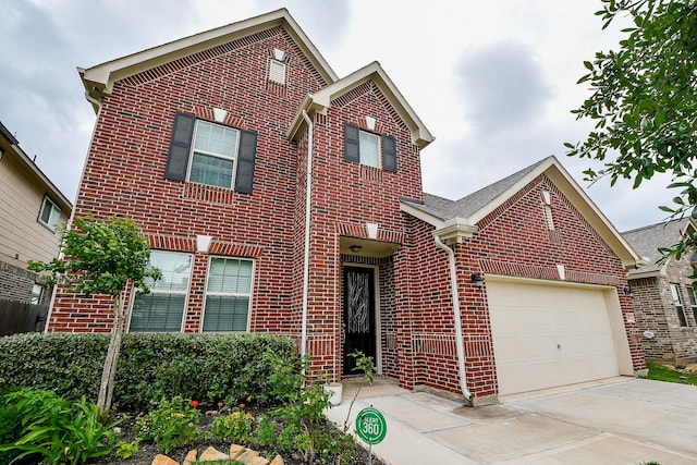 traditional-style home featuring driveway, a garage, and brick siding