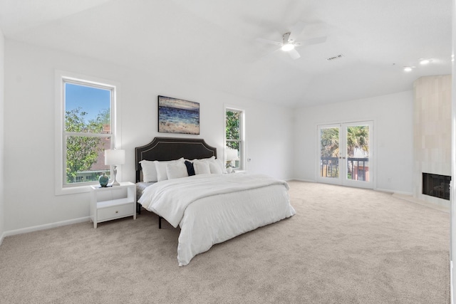 carpeted bedroom with lofted ceiling, multiple windows, baseboards, and a large fireplace