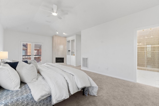 bedroom featuring baseboards, visible vents, ensuite bath, vaulted ceiling, and carpet flooring