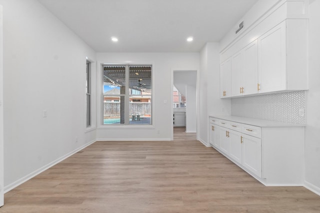 unfurnished dining area featuring visible vents, recessed lighting, light wood-type flooring, and baseboards