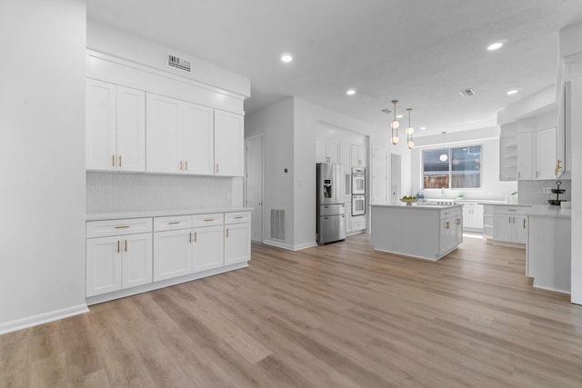 kitchen featuring open shelves, stainless steel fridge, white cabinets, and a center island