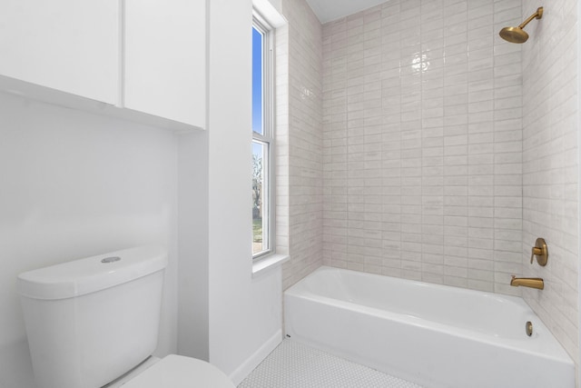 bathroom with tile patterned flooring, toilet, shower / tub combination, and baseboards