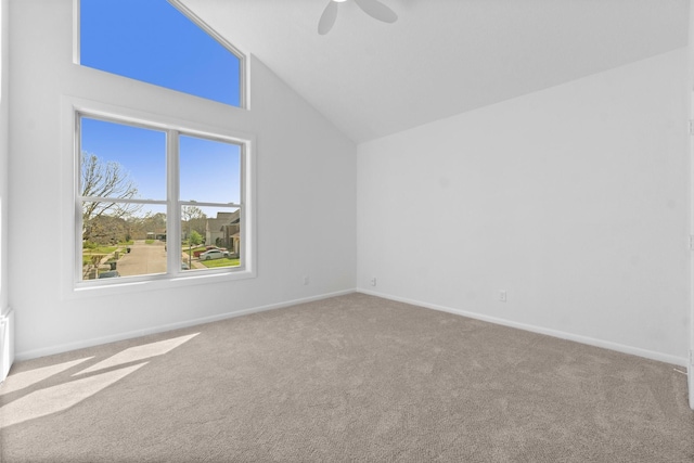 spare room with lofted ceiling, baseboards, carpet floors, and ceiling fan