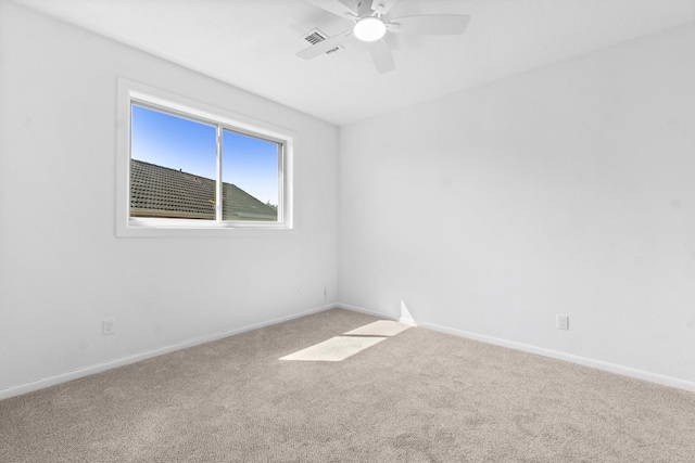 carpeted empty room featuring visible vents, baseboards, and a ceiling fan