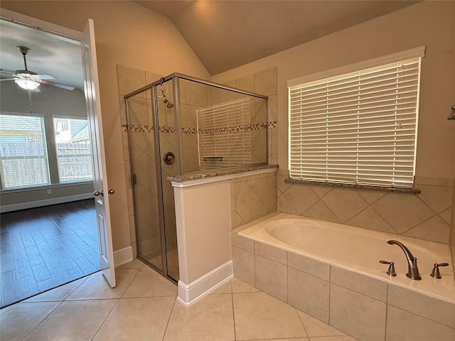 bathroom featuring a ceiling fan, tile patterned flooring, vaulted ceiling, a shower stall, and a bath