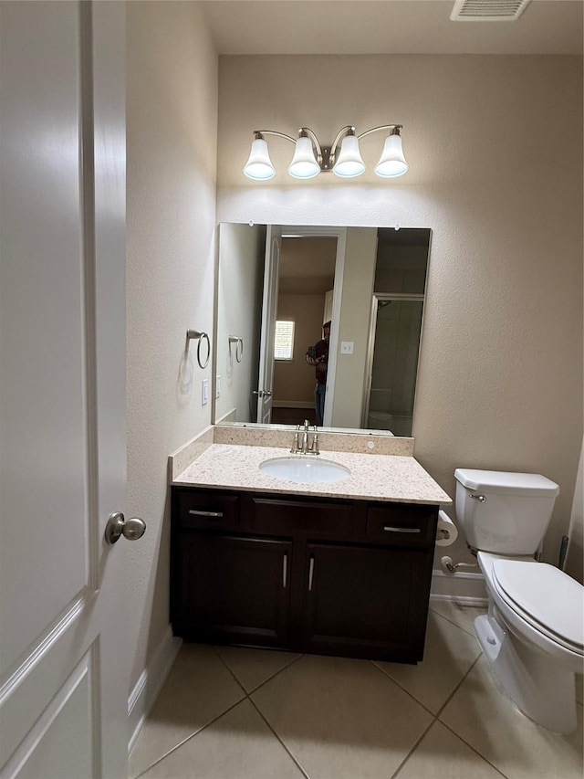 full bath with toilet, a shower stall, tile patterned flooring, and vanity