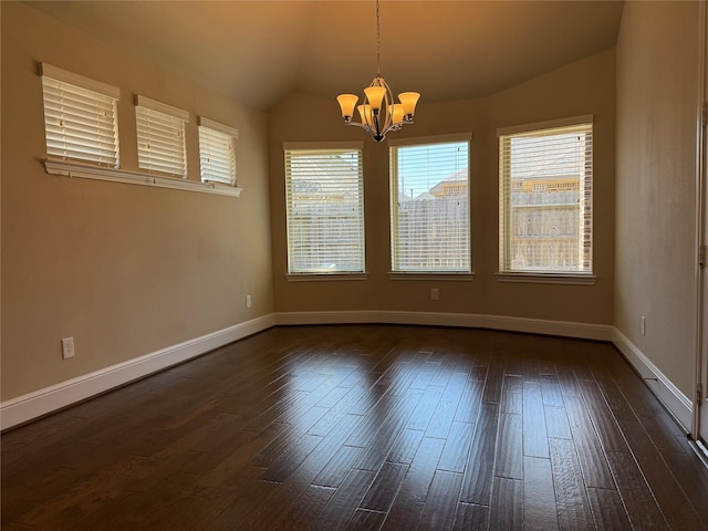 unfurnished room featuring lofted ceiling, dark wood-style floors, and plenty of natural light