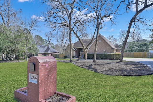 view of front of house featuring a front yard and fence