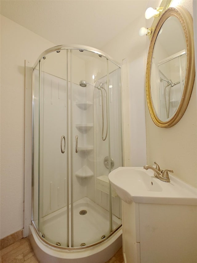 bathroom with a stall shower and vanity