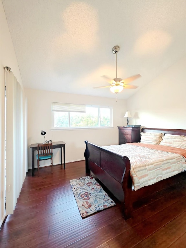 bedroom featuring ceiling fan, vaulted ceiling, and dark wood finished floors