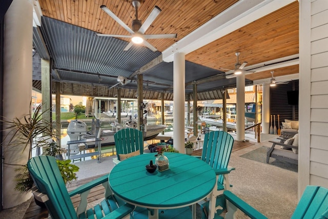 view of patio / terrace featuring a dock, boat lift, and ceiling fan