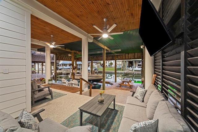 view of patio / terrace with ceiling fan, a dock, outdoor lounge area, and boat lift