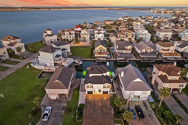 bird's eye view featuring a water view and a residential view