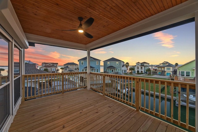 wooden terrace featuring ceiling fan and a residential view