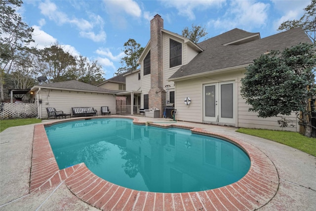 view of pool featuring a patio, french doors, and a fenced in pool