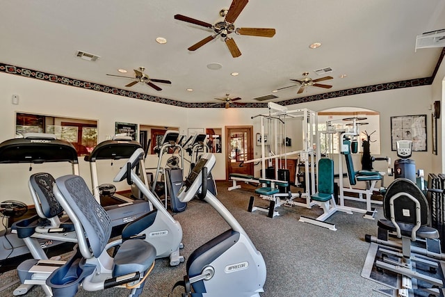 exercise room with recessed lighting, visible vents, and arched walkways