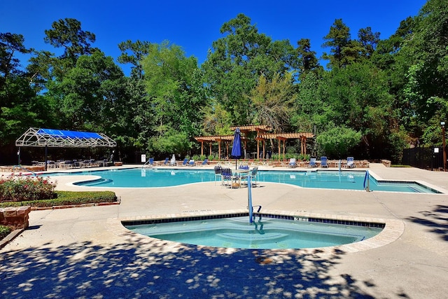 pool featuring a community hot tub, a patio area, and a pergola