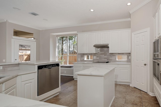 kitchen featuring stainless steel appliances, tasteful backsplash, white cabinets, and under cabinet range hood