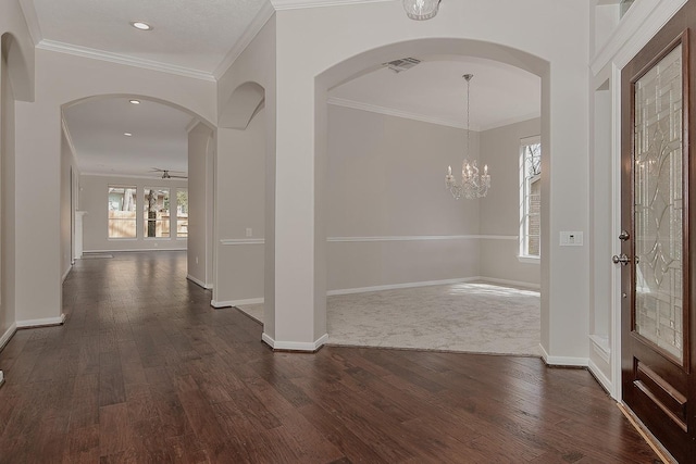 foyer entrance featuring crown molding, baseboards, and dark wood-style flooring