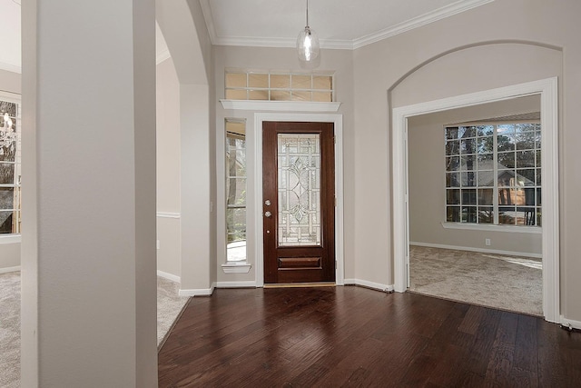 foyer with ornamental molding, dark wood-type flooring, and baseboards