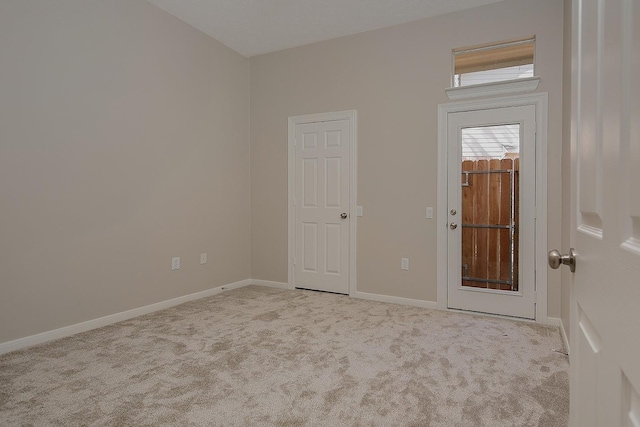 empty room featuring carpet floors and baseboards