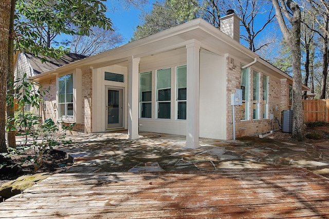 exterior space with central air condition unit, a patio, and fence