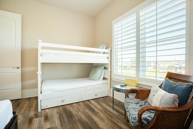 bedroom featuring wood finished floors and baseboards