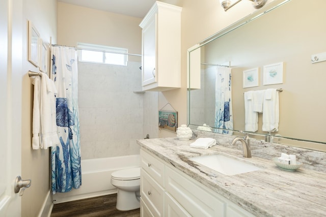 bathroom with toilet, shower / bath combo with shower curtain, wood finished floors, and vanity