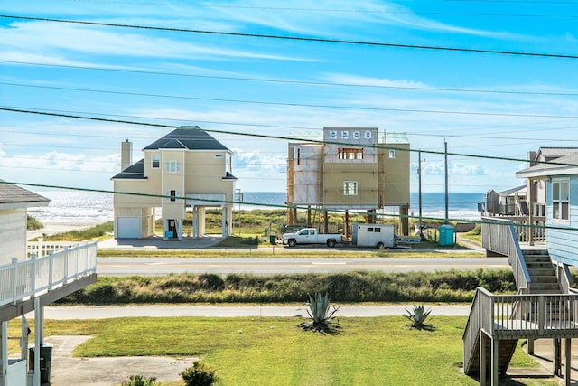 view of property's community featuring a water view and a lawn