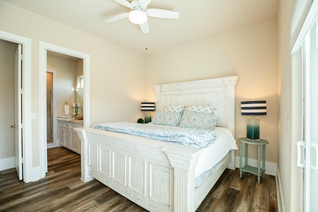 bedroom with ensuite bathroom, dark wood-type flooring, a ceiling fan, and baseboards