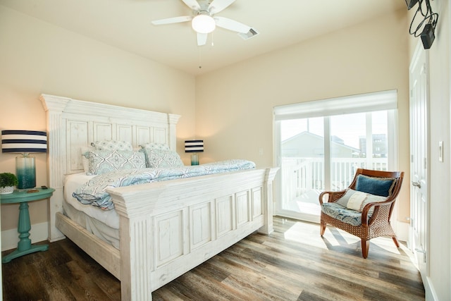 bedroom with baseboards, wood finished floors, visible vents, and access to exterior