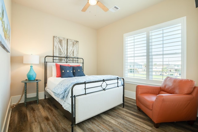 bedroom with visible vents, baseboards, and wood finished floors