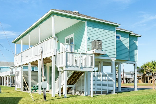 23107 Buena St, Galveston, TX 77554 - rear view of property with stairs, a yard, and a wooden deck