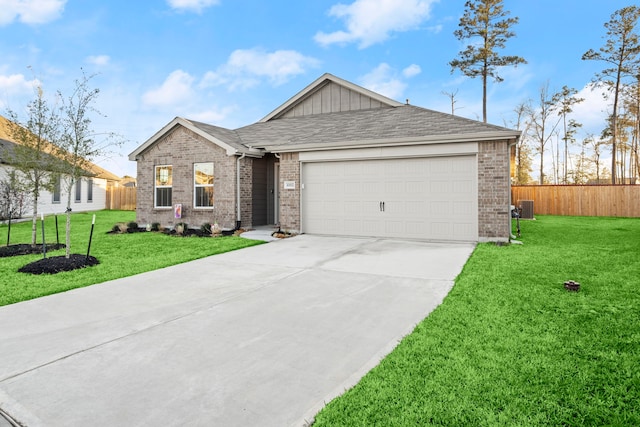 single story home with a garage, concrete driveway, a front yard, and fence