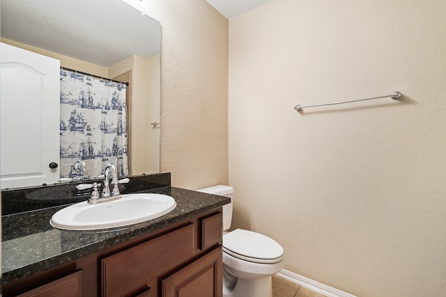 full bathroom with a textured wall, toilet, a shower with curtain, tile patterned floors, and vanity