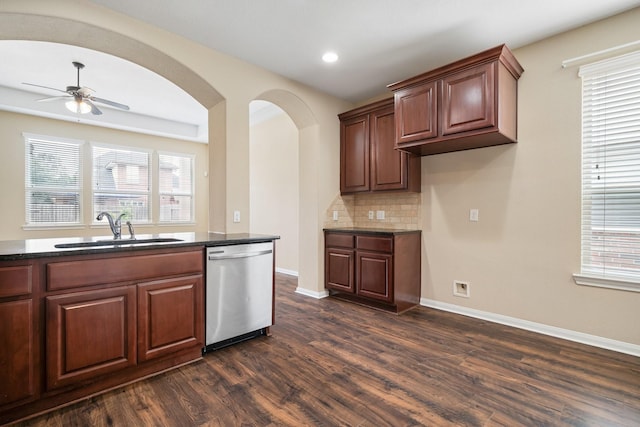 kitchen with dark wood-type flooring, plenty of natural light, a sink, and stainless steel dishwasher