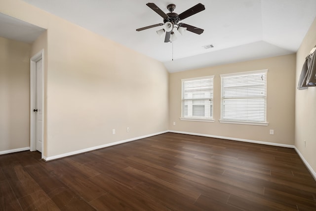 unfurnished room featuring lofted ceiling, ceiling fan, dark wood-type flooring, and baseboards