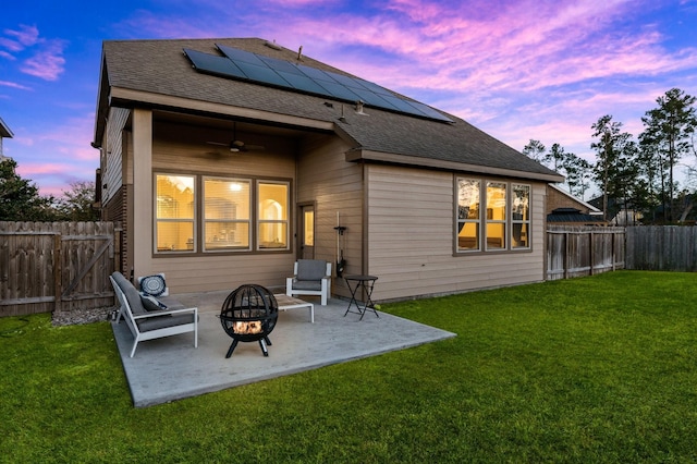 back of house with a fenced backyard, a patio, a lawn, and ceiling fan