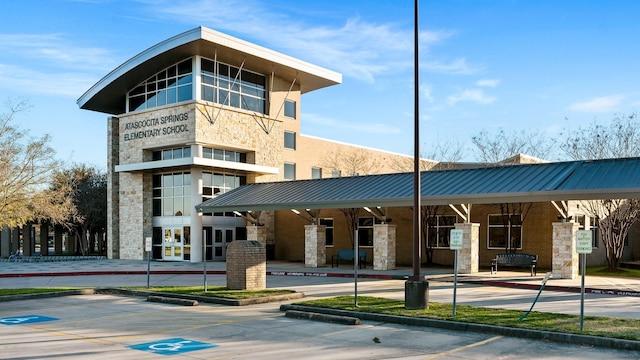 view of property featuring uncovered parking