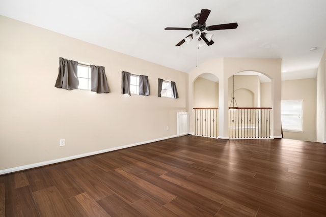 unfurnished room with plenty of natural light, baseboards, and wood finished floors